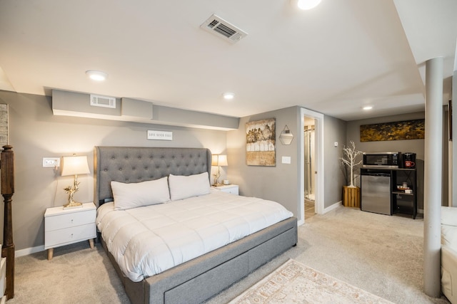 bedroom featuring baseboards, light colored carpet, visible vents, and refrigerator