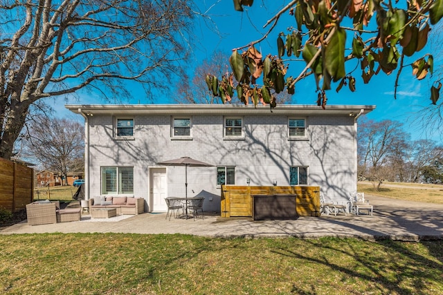 back of property with a patio area, a yard, and an outdoor living space