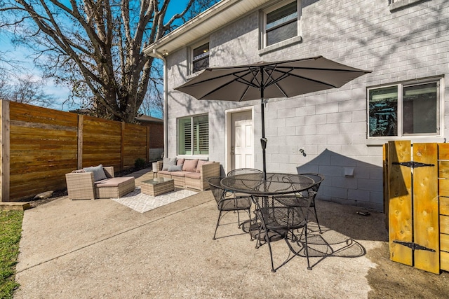 view of patio / terrace featuring outdoor dining space, outdoor lounge area, and fence