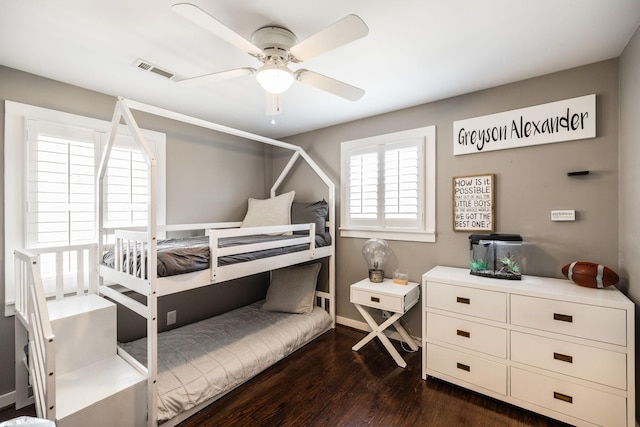 bedroom featuring ceiling fan, dark wood finished floors, and visible vents