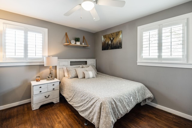 bedroom with ceiling fan, dark wood-type flooring, and baseboards