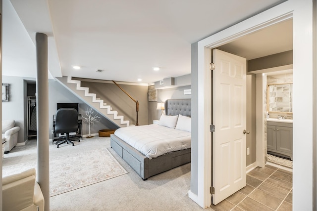 bedroom featuring recessed lighting, light colored carpet, a sink, and baseboards