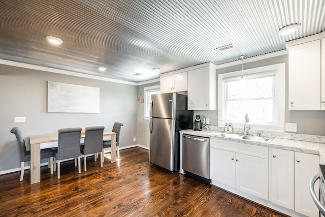 kitchen featuring stainless steel appliances, a sink, light countertops, and white cabinets