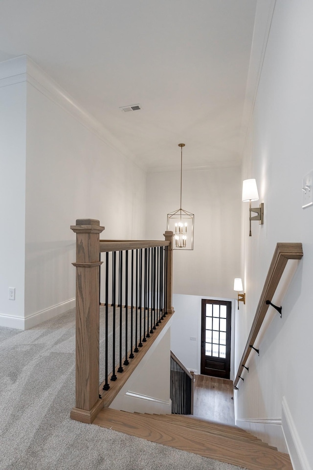 stairs with baseboards, carpet, visible vents, and an inviting chandelier