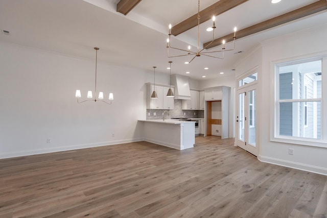 kitchen featuring white cabinetry, decorative light fixtures, and an inviting chandelier