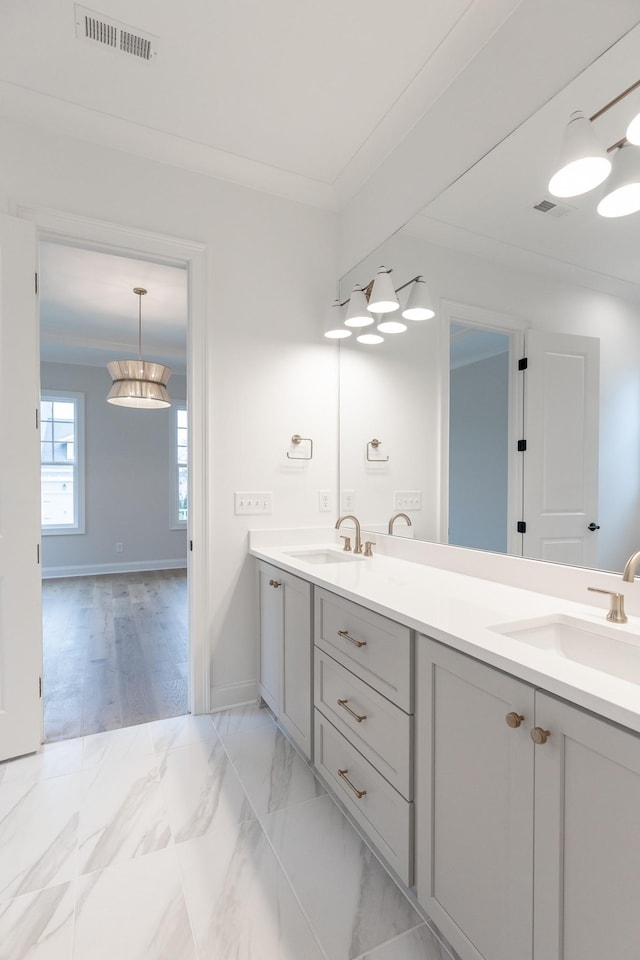 full bath with marble finish floor, a sink, and visible vents