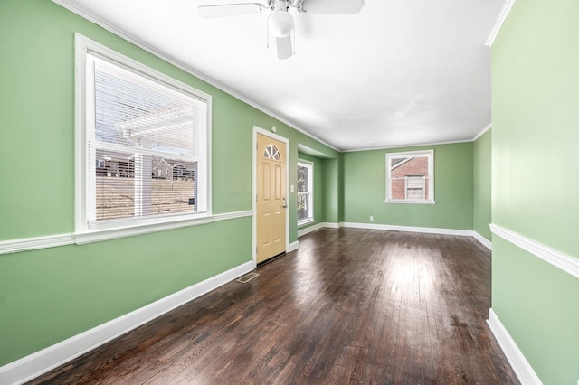 interior space with baseboards, dark wood-style floors, and crown molding