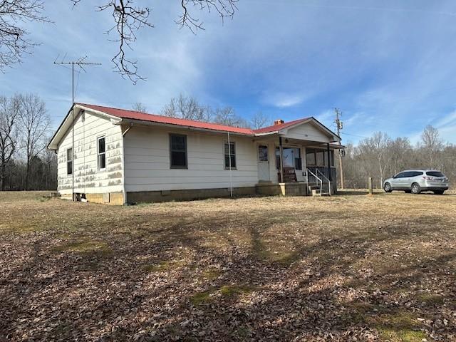 view of front of home with a porch and metal roof