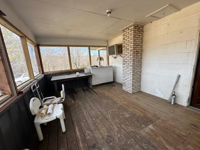 sunroom with a wall mounted air conditioner