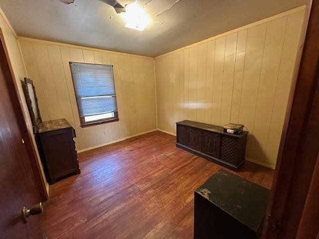 spare room featuring dark wood finished floors and baseboards