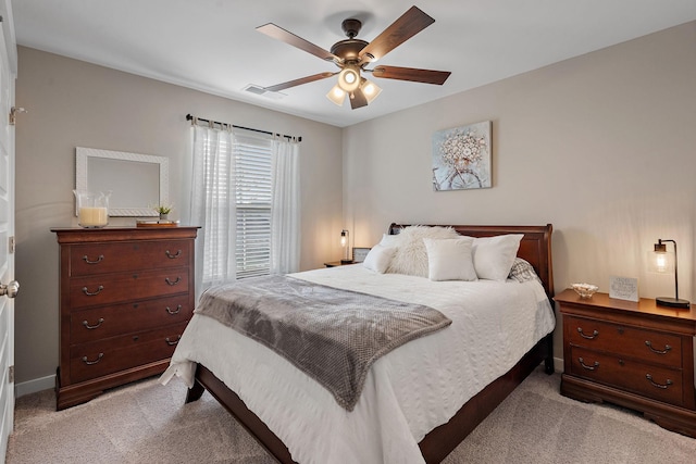 bedroom featuring baseboards, a ceiling fan, visible vents, and light colored carpet