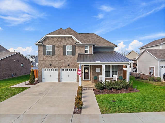 traditional-style home with driveway, a standing seam roof, covered porch, a front lawn, and brick siding