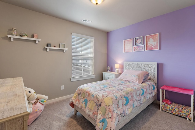 carpeted bedroom featuring visible vents and baseboards