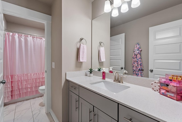 bathroom featuring curtained shower, toilet, vanity, baseboards, and marble finish floor