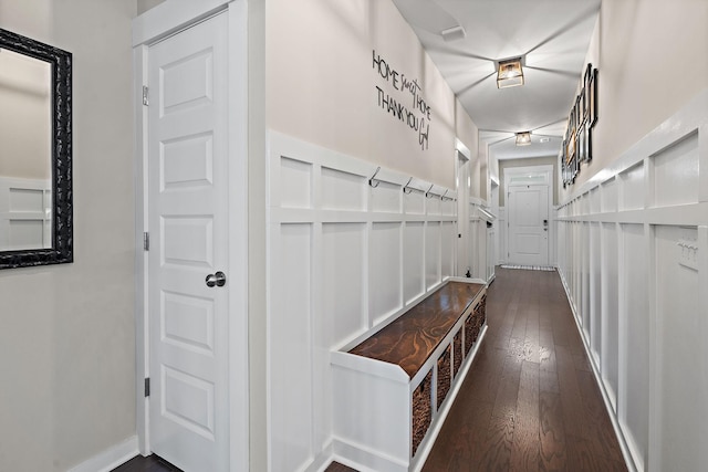 hallway with dark wood-type flooring and baseboards