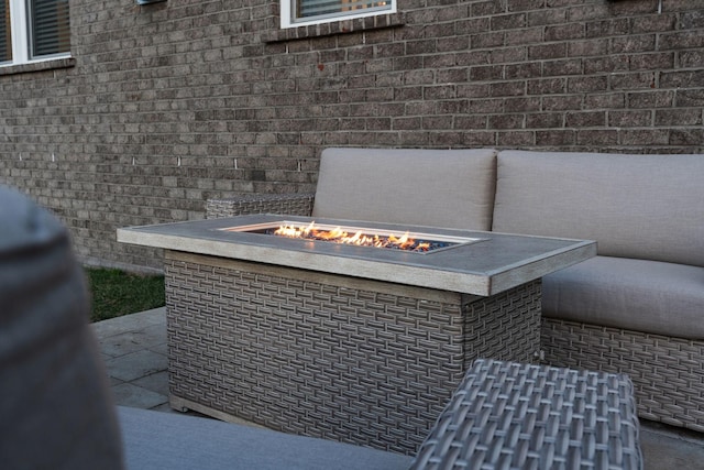 details with a fire pit and brick siding