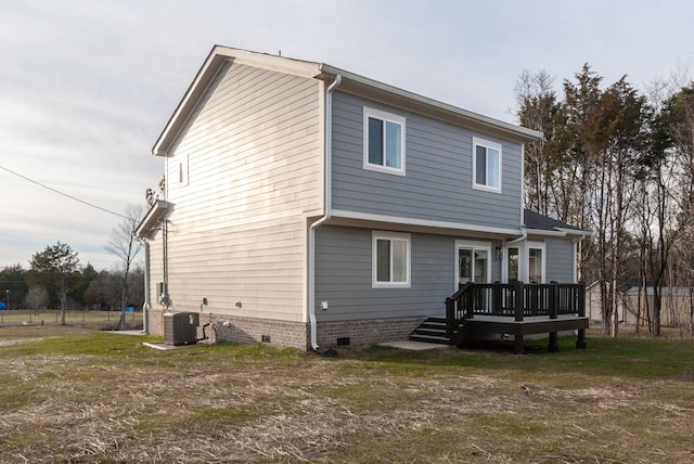 back of property with a yard, crawl space, cooling unit, and a wooden deck