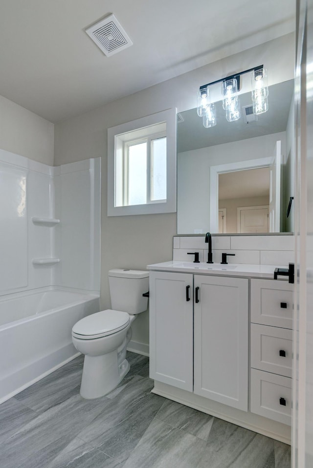 bathroom with baseboards, visible vents, toilet,  shower combination, and vanity