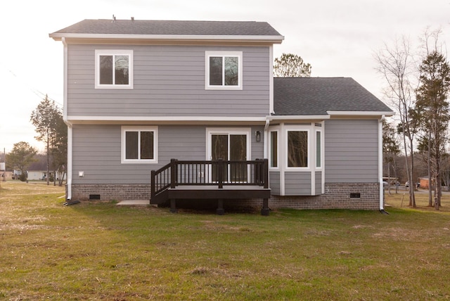 rear view of property featuring a shingled roof, crawl space, a lawn, and a deck