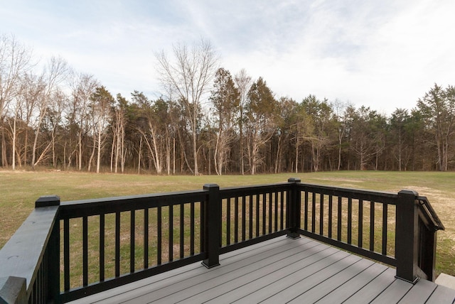 wooden terrace with a view of trees and a lawn