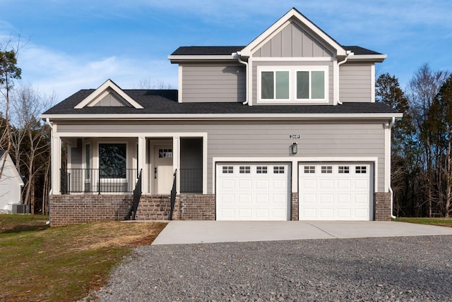 view of front of home featuring an attached garage, cooling unit, brick siding, driveway, and board and batten siding