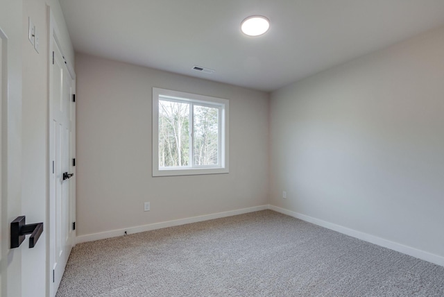 unfurnished bedroom with carpet floors, baseboards, and visible vents