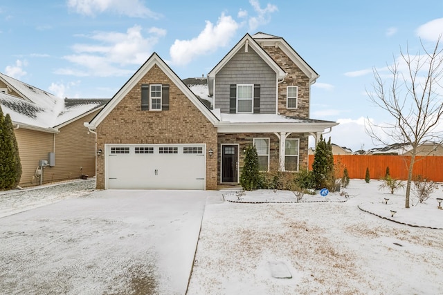 view of front of property with a garage, driveway, brick siding, and fence