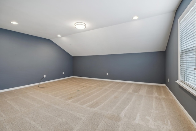 additional living space featuring carpet, vaulted ceiling, baseboards, and recessed lighting