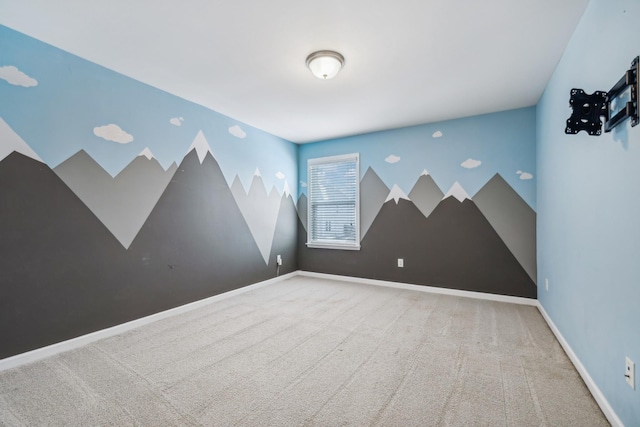 spare room with carpet and baseboards