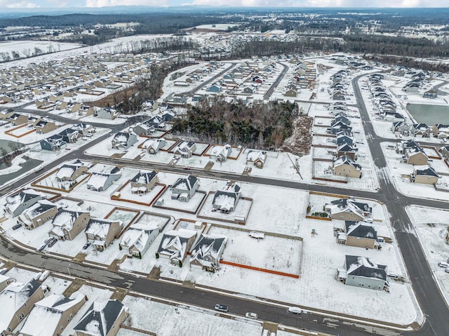 snowy aerial view featuring a residential view