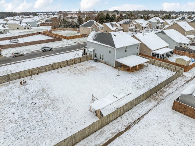 snowy aerial view featuring a residential view