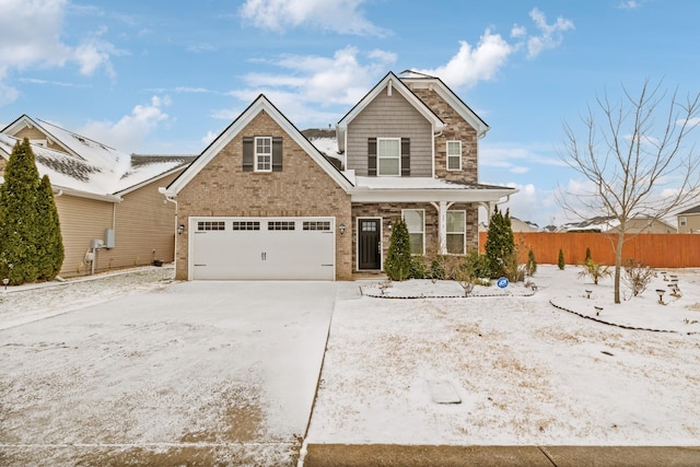 traditional-style home featuring driveway, a garage, fence, and brick siding