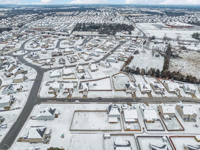 snowy aerial view featuring a residential view