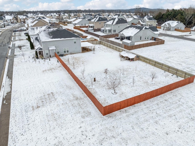 snowy aerial view featuring a residential view