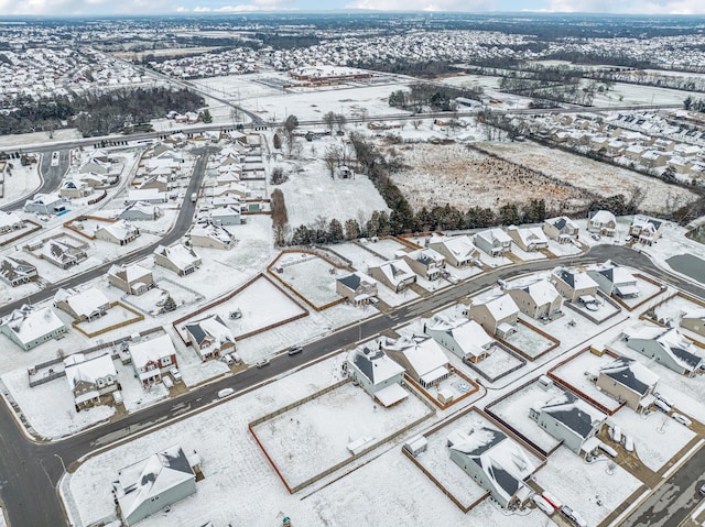 snowy aerial view featuring a residential view