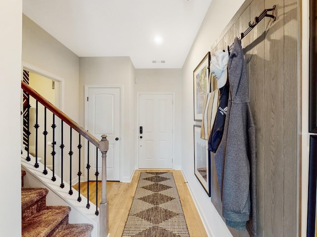 mudroom featuring light wood-style floors, visible vents, and baseboards