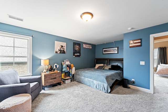 bedroom with carpet flooring, visible vents, and baseboards