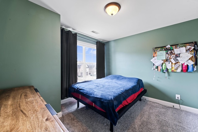 bedroom featuring baseboards, visible vents, and dark colored carpet