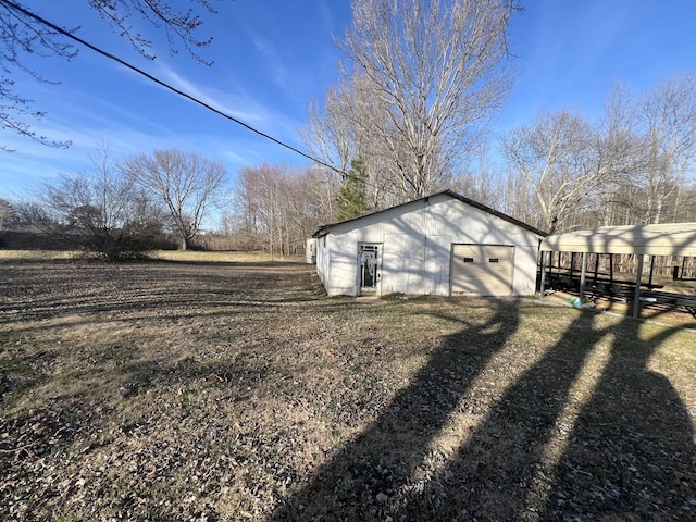 view of home's exterior featuring a yard, an outbuilding, driveway, and a detached garage