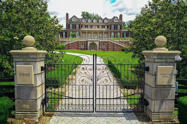 view of gate featuring a yard