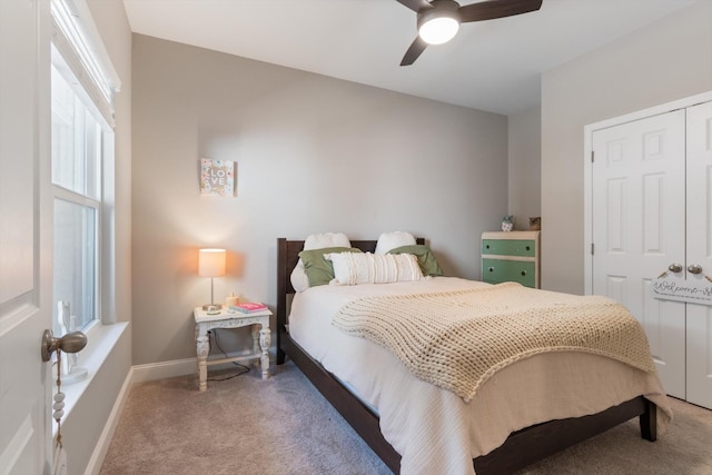 bedroom with carpet floors, a ceiling fan, baseboards, and a closet