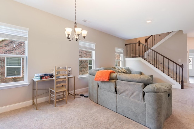 carpeted living area featuring baseboards, stairway, and a notable chandelier