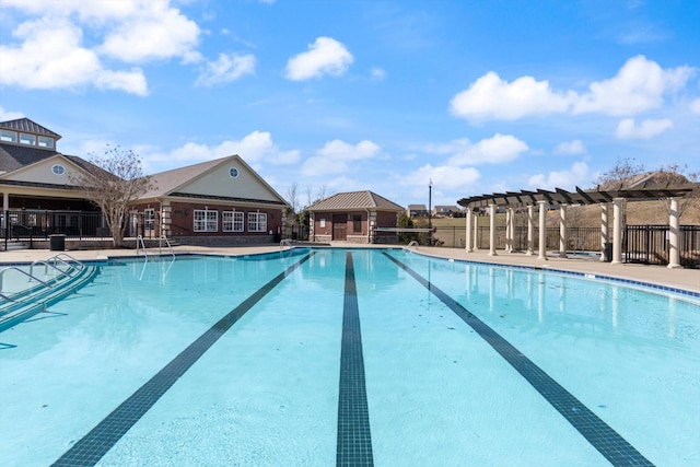 community pool with fence and a pergola