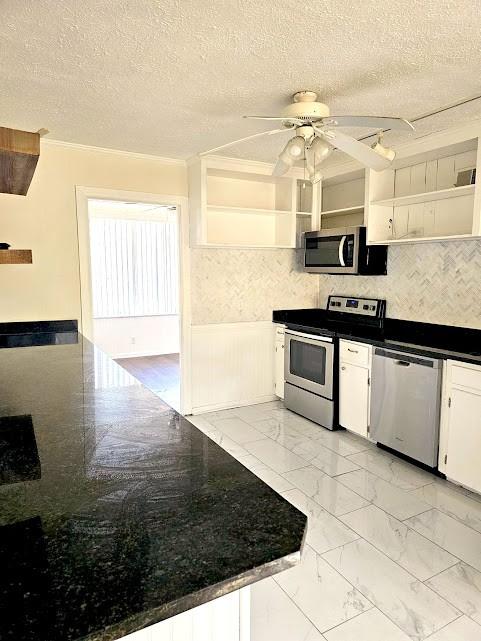 kitchen with marble finish floor, open shelves, stainless steel appliances, a ceiling fan, and white cabinetry