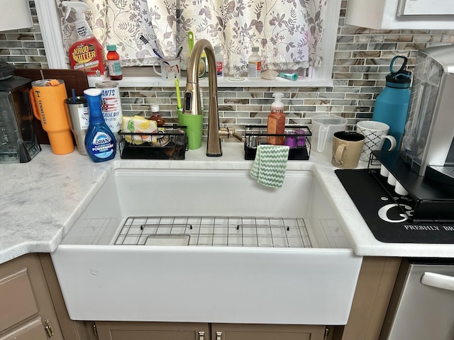 room details featuring tasteful backsplash, light countertops, and a sink