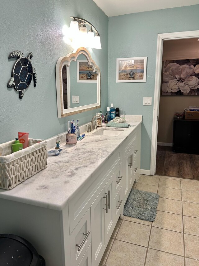 bathroom featuring baseboards, vanity, and tile patterned flooring