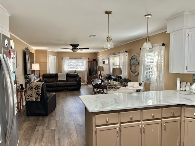 kitchen featuring wood finished floors, a peninsula, open floor plan, and freestanding refrigerator