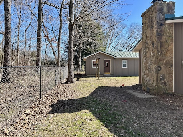 view of yard with an outbuilding and fence