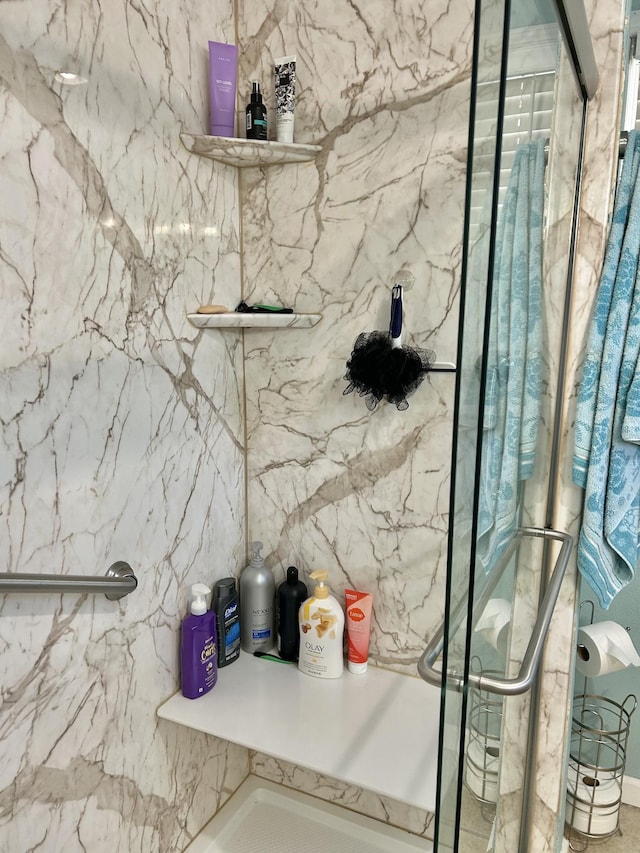 full bathroom featuring a marble finish shower