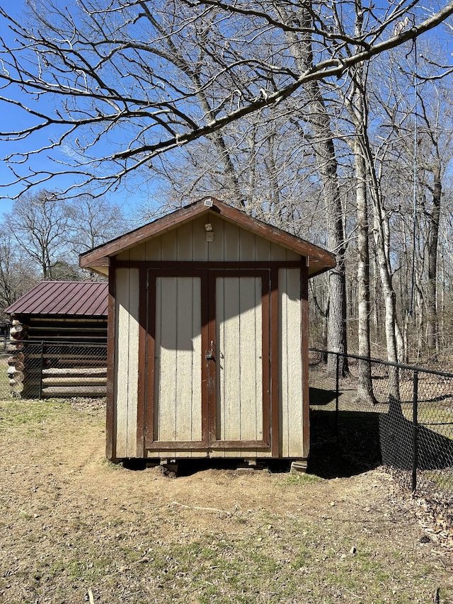 view of shed with fence